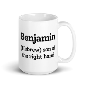 May include: White ceramic mug with the word "Benjamin" in black bold font. Below the name is the text "(Hebrew) son of the right hand" in black font.