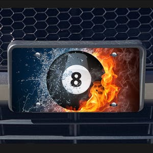 May include: A black and white 8-ball with water and fire effects. The 8-ball is surrounded by flames and water droplets. The background is a black and white checkered pattern.