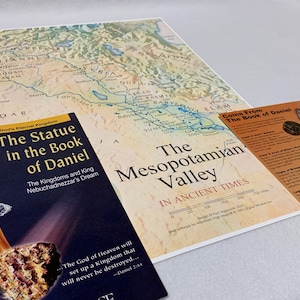 May include: A book titled "The Statue in the Book of Daniel" with a gold and silver statue on the cover. The book is open to a page with the text "The God of Heaven will set up a Kingdom that will never be destroyed... -Daniel 2:44".  A map of the Mesopotamian Valley in ancient times is in the background.  A card with the title "Coins From The Book of Daniel" shows images of ancient coins.