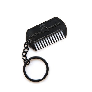 May include: Black metal keychain with a comb and a logo that says "Golden Spartan" with a Spartan helmet graphic.