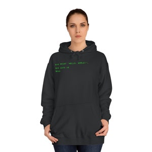 May include: Black hooded sweatshirt with a green code snippet on the front that reads: "310 PRINT "HELLO, WORLD!" 320 GOTO 10 330 RUN."