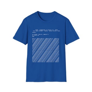 May include: A royal blue t-shirt with white text that reads "COMMODORE 64 BASIC V2" and a code snippet that includes the line "10 PRINT "HELLO, WORLD!" :"