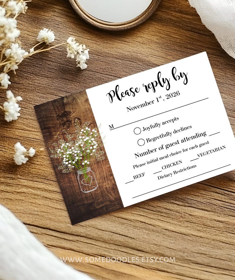 May include: A rectangular wedding RSVP card with a white background and a dark wood grain panel on the left. The card features a graphic of a mason jar with baby's breath flowers and text that reads Please reply by November 1st, 2026.
