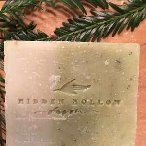 May include: A green and white bar of soap with the words "HIDDEN HOLLOW FARM" embossed on the front.