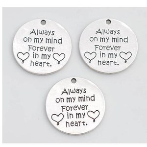 May include: Three silver charm pendants with the text "Always on my mind Forever in my heart." and two small heart designs.