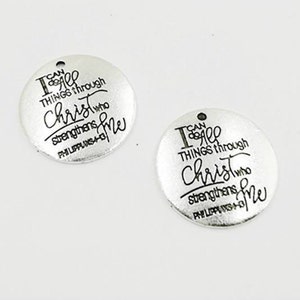 May include: Two silver charm pendants with the text "I can do all things through Christ who strengthens me" and the scripture reference "Philippians 4:13".