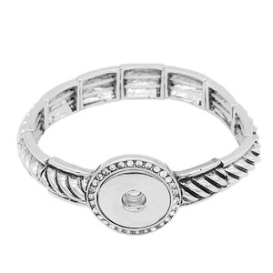 May include: Silver bracelet with a snap-on charm. The bracelet has a braided design and is adorned with clear rhinestones.