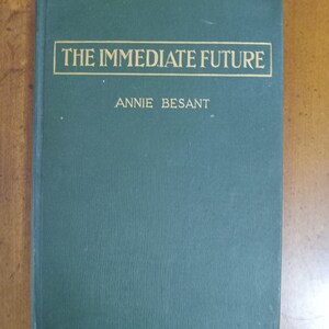 May include: A green hardcover book with gold lettering on the front cover. The title is "THE IMMEDIATE FUTURE" and the author is "ANNIE BESANT".