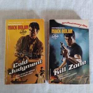 May include: Two paperback books with yellow and black covers. The books are part of the Mack Bolan series, titled "Cold Judgment" and "Kill Zone". The covers feature a man holding a gun and the text "The Executioner".
