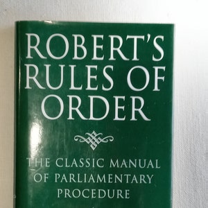May include: A green book with the title "Robert's Rules of Order" and the subtitle "The Classic Manual of Parliamentary Procedure".