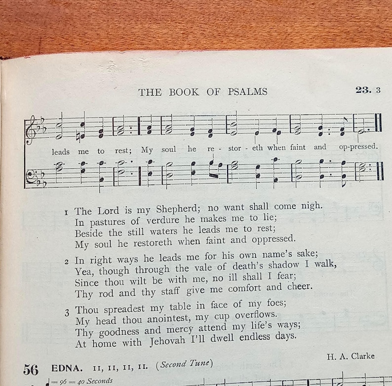May include: A page from a hymnal titled The Book of Psalms, featuring musical notation on a staff with lyrics including The Lord is my Shepherd; no want shall come nigh. The text is printed in black ink on white paper, with the composer H. A. Clarke listed.