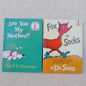 May include: Two children's books, "Are You My Mother?" by P.D. Eastman and "Fox in Socks" by Dr. Seuss. Both books are part of the Beginner Books series and feature colorful illustrations.