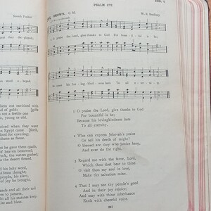 May include: An open book displaying The Book of Psalms, Psalm CVI, with printed musical notation and lyrics. The page features the title, hymn number 288, composer W. B. Bradbury, and verses 1 through 4. The paper edges have thin red stripes.