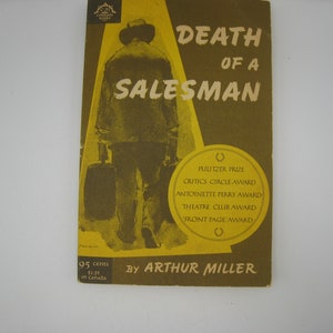 May include: A yellow and brown book cover with the title "Death of a Salesman" by Arthur Miller. The cover features a black and white illustration of a man walking away from the viewer, carrying a suitcase.
