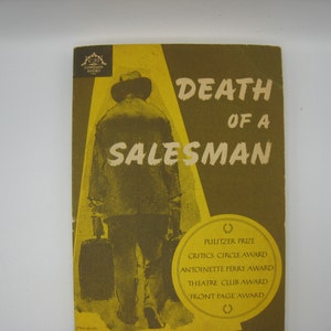May include: A yellow and brown book cover with the title "Death of a Salesman" and a silhouette of a man walking away. The book cover also lists awards the play has won, including the Pulitzer Prize, Critics Circle Award, Antoinette Perry Award, Theatre Club Award, and Front Page Award.