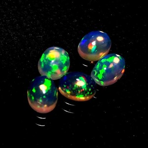 50/% discount on 0.60 ct Ethiopian welo opal.. Fire opal CABOCHON... 8x6 mm