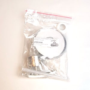 May include: A clear plastic bag containing a stainless steel mason jar pump kit in antique nickel. The kit includes a pump, a lid, and a gasket. The bag also includes a small white plastic piece and a white straw. The product label reads "Stainless Steel Mason Jar Pump Kit Antique Nickel #PKMJRPB Pro Woodworking Products Made in China."