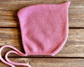 Pink pixie bonnet for baby, hand knitted with soft pure merino wool