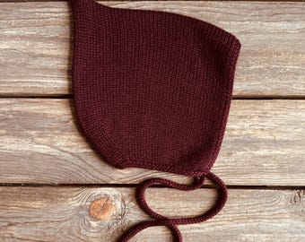 Burgundy pixie bonnet for baby, hand knitted with soft pure merino wool