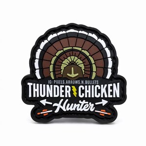 May include: A black patch with a turkey fan design in brown, white, and olive green. The text "THUNDER CHICKEN Hunter" is displayed in white, with a yellow lightning bolt. Arrows and the text "IG: PIXELS.ARROWS.N.BULLETS" are also included.
