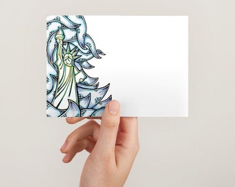 May include: A white card with a blue and green illustration of the Statue of Liberty on the left side. The illustration is surrounded by a swirling pattern of blue and green.
