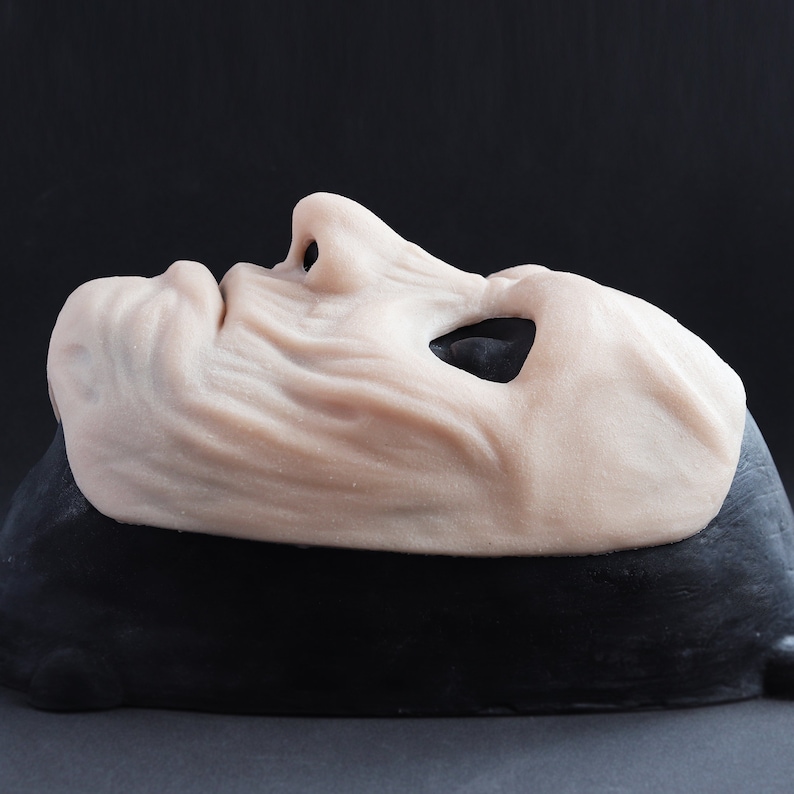 Ghoul Mask in vanilla shade on a black surface at a steep angle