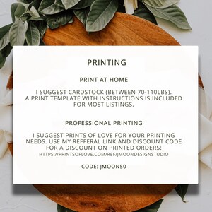 May include: A white rectangular sign with the word "PRINTING" at the top. The sign provides printing suggestions, including cardstock weight and a discount code for printed orders. The sign is surrounded by green leaves, white flowers, and a wooden surface.