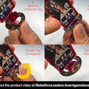 May include: A close-up of a red and black plastic card holder with a cardboard ring. The card holder is designed to hold a card game card. The card holder is shown in four different positions, demonstrating how to use it. The text on the card reads "Wedge Antilles".