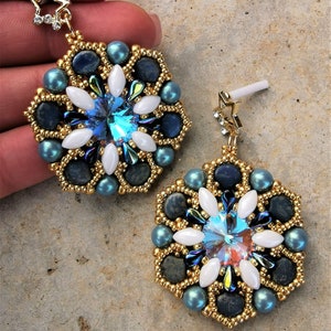 May include: A pair of gold and blue beaded earrings with a crystal center and a star charm. The earrings are made with a variety of beads, including blue, gold, and white.