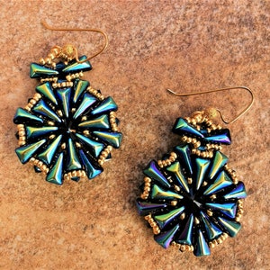 May include: A pair of iridescent blue and black earrings with gold accents. The earrings are made of small beads and have a geometric design.