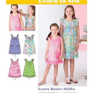 May include: Simplicity 2241 Learn to Sew pattern envelope featuring illustrations and photographs of sleeveless dresses with yokes, ruffles, and pockets. The text includes Learn Basics Skills, choose the right size, cut out a pattern, apply trim, apply a yoke, apply bias tape, apply ruffle, and stitch a hem.
