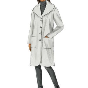 May include: A long, white coat with a wide collar, button closure, and two patch pockets. The coat is worn over a black turtleneck and black pants.