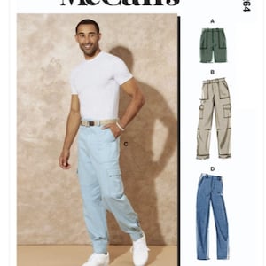 May include: A sewing pattern for men's pants with four different views. The pattern includes a pair of green cargo pants, a pair of beige cargo pants, a pair of light blue cargo pants, and a pair of blue jeans. The pattern is McCall's M8264.