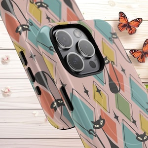 May include: A phone case with a retro design featuring black cat silhouettes, diamonds, and starbursts in a palette of pink, teal, yellow, and orange. The case has a glossy finish and a black camera lens surround.