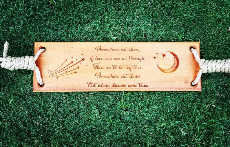 Puede incluir: Un letrero de madera con una cita sobre el amor y los sue&ntilde;os. El letrero est&aacute; decorado con una luna creciente y estrellas fugaces. La cita dice: "En alg&uacute;n lugar ah&iacute; fuera, si el amor puede vernos a trav&eacute;s. Entonces estaremos juntos. En alg&uacute;n lugar ah&iacute; fuera. Donde los sue&ntilde;os se hacen realidad."