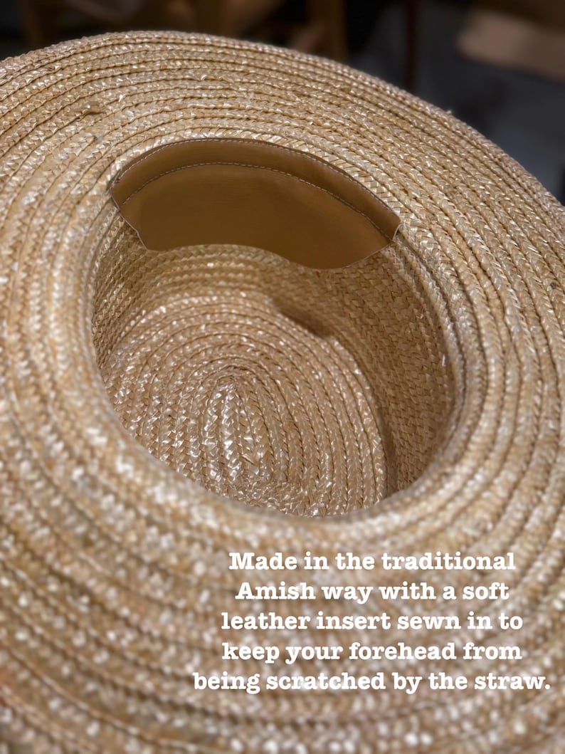 May include: A straw hat with a wide brim and a brown leather insert sewn into the inside. The hat is made in the traditional Amish way. The text on the image says: Made in the traditional Amish way with a soft leather insert sewn in to keep your forehead from being scratched by the straw.