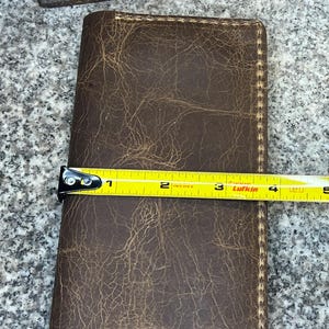 This photo shows that the rodeo wallet is 3.75 inches wide when closed.