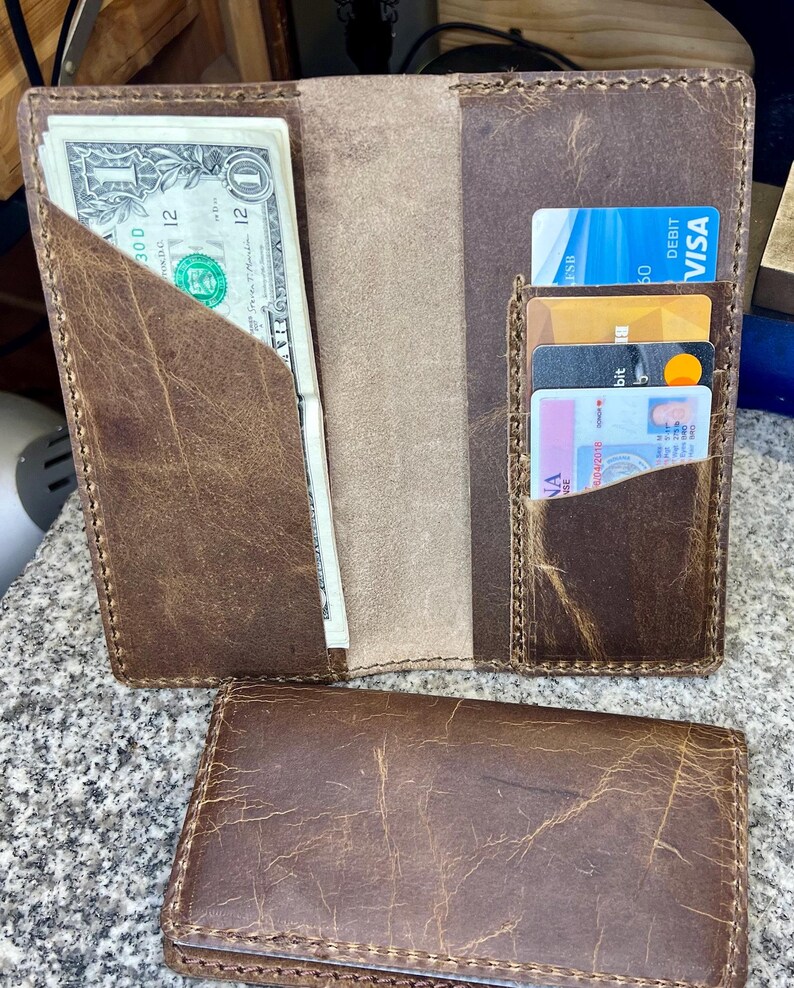 This photo shows the rodeo wallet when open. It shows a left slot for cash and four slots on the right side for credit cards.