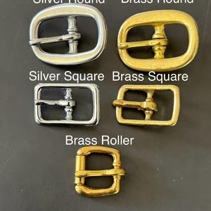 May include: An assortment of metal buckles in silver and brass. The image displays round and square buckles, along with a brass roller buckle. Text on the image reads "Silver Round", "Brass Round", "Silver Square", "Brass Square", "Brass Roller", and "Buckle Options".