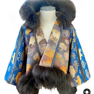 May include: A unique, patterned jacket with a fur-lined hood and trim. The jacket features a blue, brown, and orange design with bison and geometric patterns. The trim and hood are a dark, fluffy fur. The jacket is displayed on a mannequin.