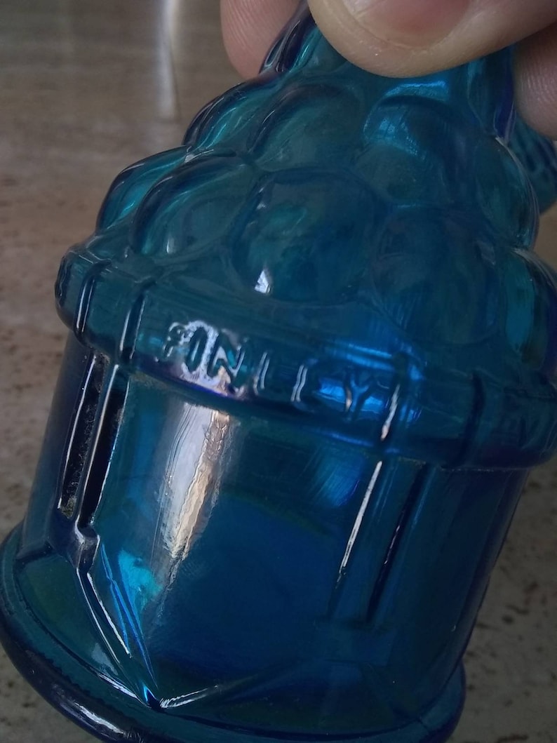 Peut inclure: Une bouteille en verre bleu avec un motif textur&eacute; et le mot "FINELY" en relief sur le c&ocirc;t&eacute;.