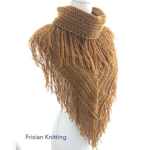 May include: A crocheted cowl with a triangular shape and long fringe. The cowl is a warm mustard yellow colour.
