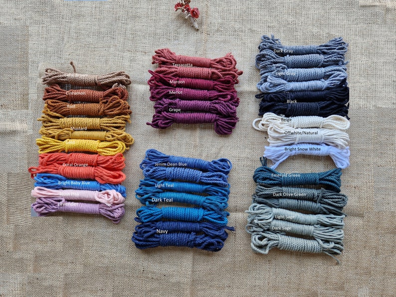 May include: Assortment of cotton rope in various colors, including terracotta, maroon, merlot, grape, dark gray, light gray, black, beige, off-white, bright snow white, denim blue, light teal, dark teal, navy, emerald green, dark olive green, light sage, and dark sage.
