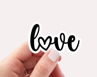 May include: A white sticker with black lettering that says "love" with a small heart in the "o".