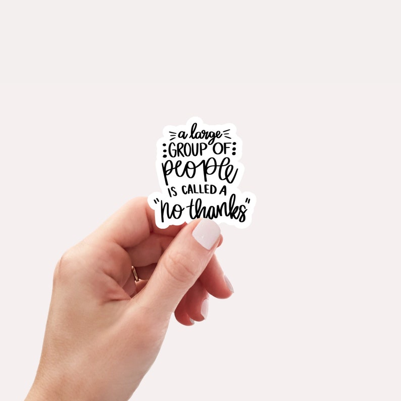 May include: A white sticker with black text that reads "a large group of people is called a "no thanks""
