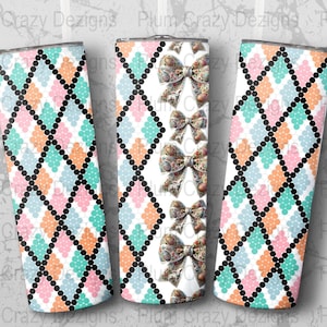 May include: Three stainless steel tumblers with a white background and a pattern of black diamonds with pink, blue, and orange circles. The center tumbler has a vertical pattern of bows with a floral design.