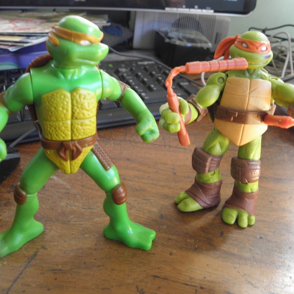 2 action figures, 4 inches tall, TMNT, Michelangelo, Raphael, 2012 Mickey with nun chucks, Raph, squeeze legs together, he punches