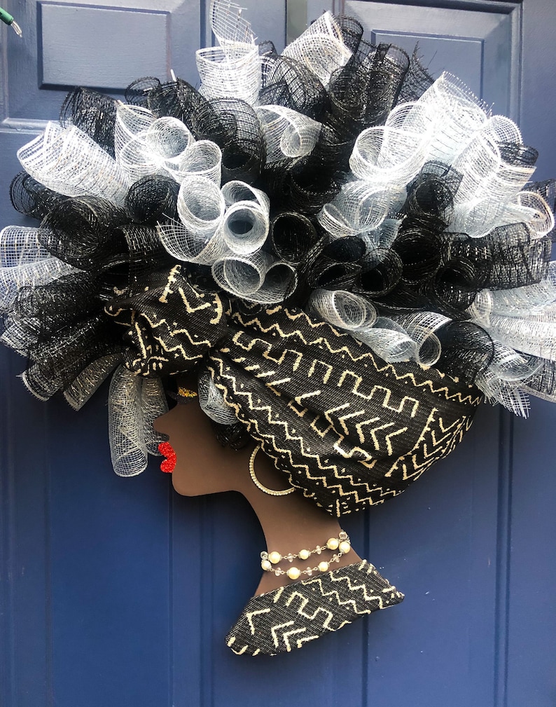 A woman afro diva made of paper on a color background