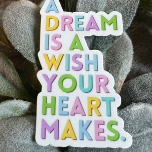 May include: A colorful sticker with the text "A dream is a wish your heart makes."