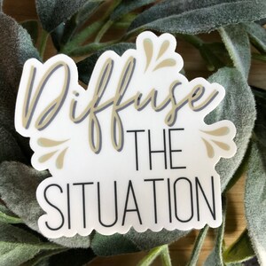 May include: White sticker with a gold and gray outline. The sticker says "Diffuse the Situation" with a decorative flourish.